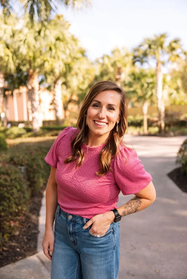 Kayla Freeman, standing outdoors on a path, one hand in her pocket.