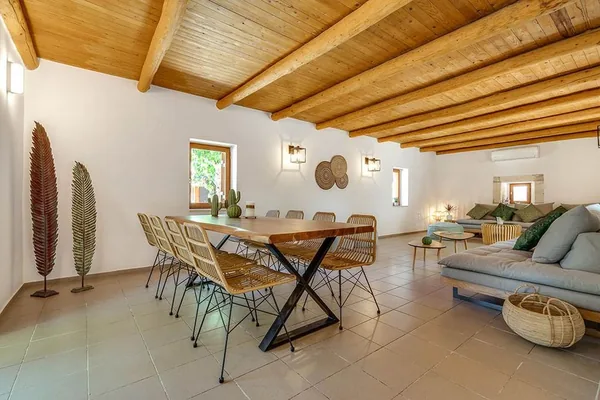 The dining room at Armonia, a long timber table under a beamed ceiling.